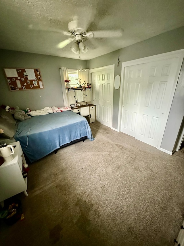 950 Woodbine St, Willard, OH 44890 - carpeted bedroom featuring multiple closets, a ceiling fan, and a textured ceiling