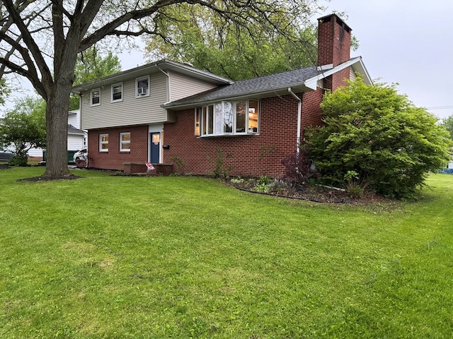 950 Woodbine St, Willard, OH 44890 - split level home with brick siding, a chimney, and a front lawn