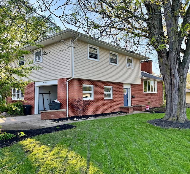 950 Woodbine St, Willard, OH 44890 - view of front of house featuring an attached garage, brick siding, a front yard, and a chimney
