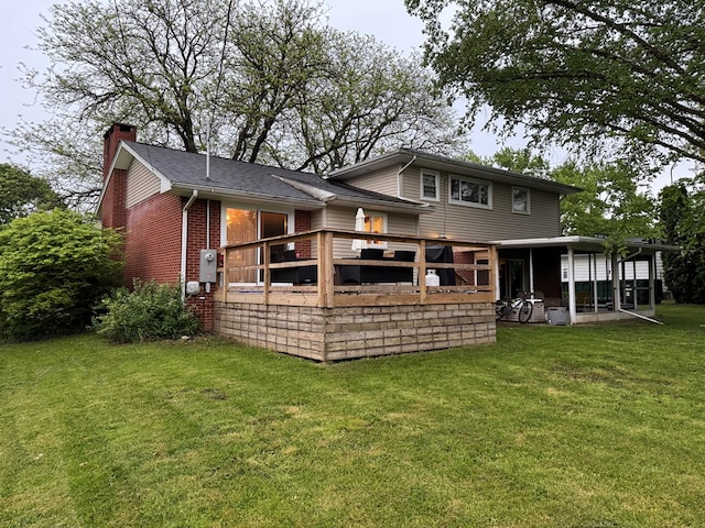 950 Woodbine St, Willard, OH 44890 - rear view of house featuring brick siding, a chimney, a lawn, and a wooden deck