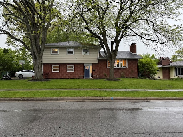 950 Woodbine St, Willard, OH 44890 - colonial house featuring brick siding, a chimney, and a front yard