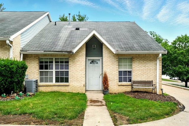 1696 Riva Rdg, Mansfield, OH 44904 - view of front of house with roof with shingles, brick siding, and a front lawn