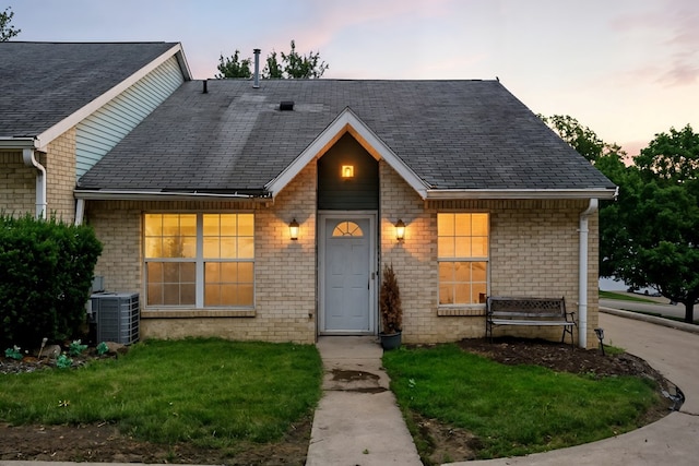 1696 Riva Rdg, Mansfield, OH 44904 - view of front of house featuring brick siding, a front yard, and a shingled roof