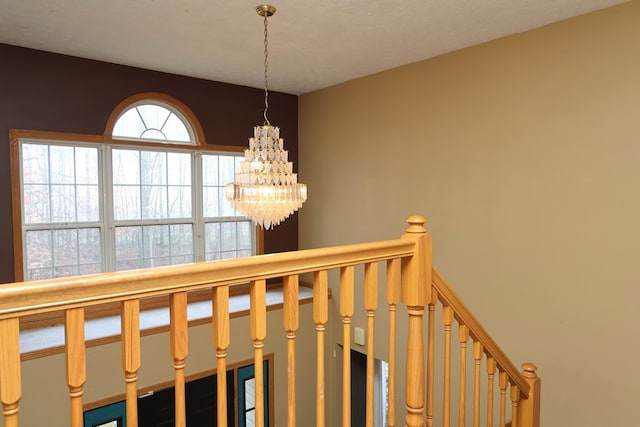 hallway featuring an inviting chandelier