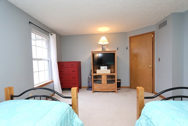 bedroom featuring a textured ceiling and carpet floors