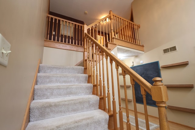 stairs featuring a high ceiling