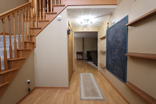 interior space featuring a textured ceiling and light hardwood / wood-style flooring