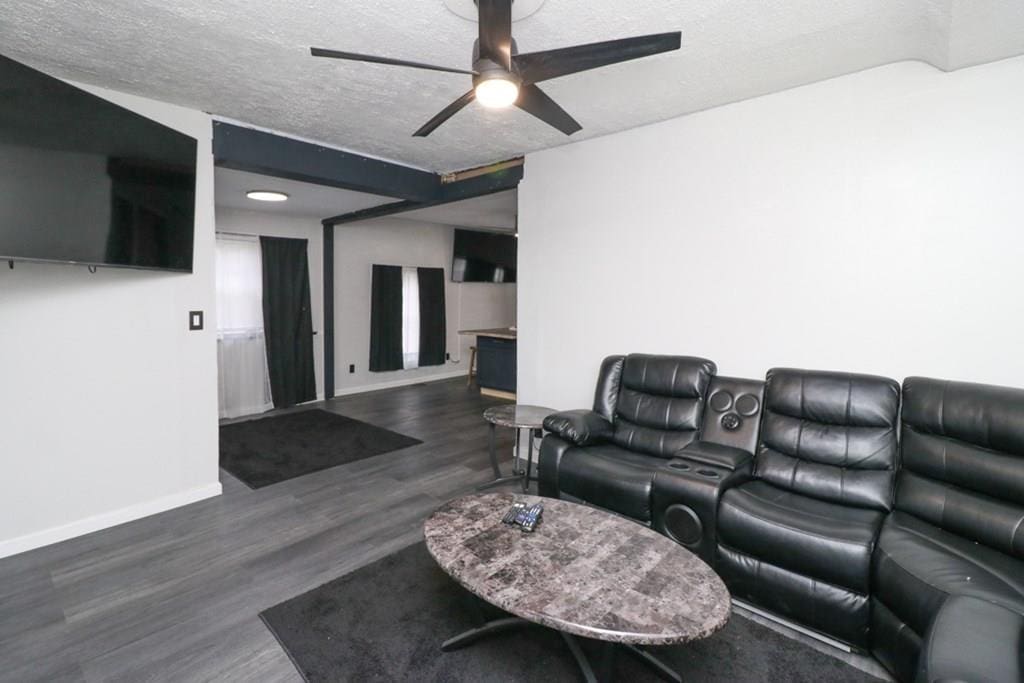 195 N Benton St, Mansfield, OH 44903 - living room featuring a textured ceiling, ceiling fan, and dark hardwood / wood-style floors