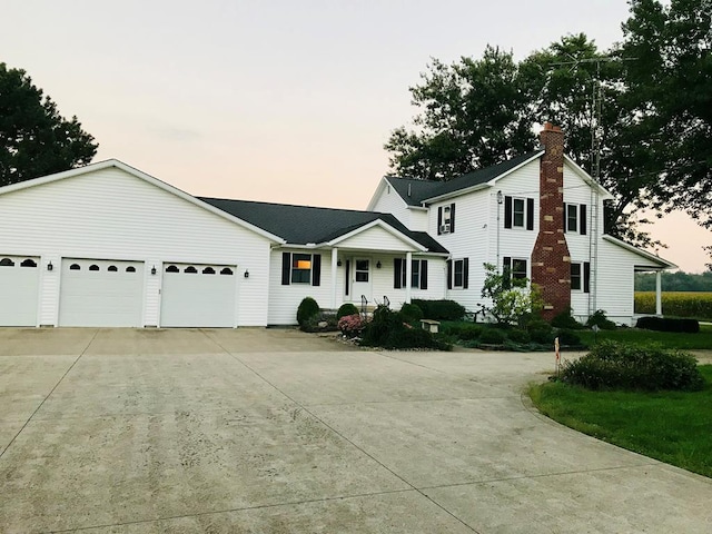 7958 Auburn Center Rd, Shelby, OH 44875 - view of front of property featuring an attached garage, a chimney, and concrete driveway