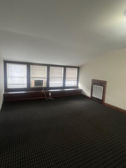 379 S Main St, Mansfield, OH 44902 - carpeted empty room featuring lofted ceiling and baseboards