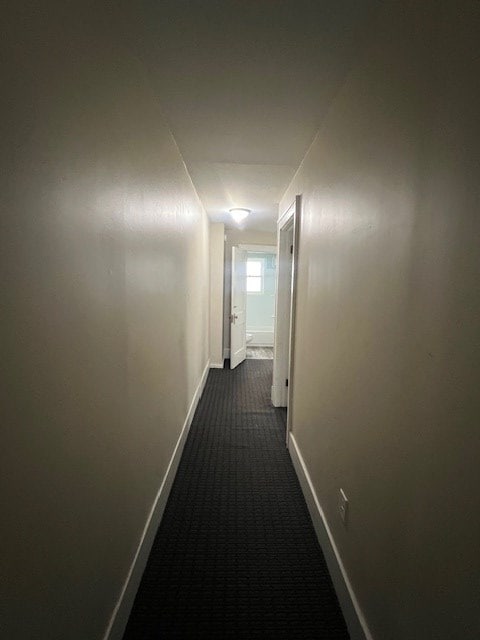 379 S Main St, Mansfield, OH 44902 - hallway featuring dark carpet and baseboards