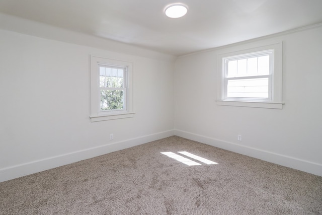empty room featuring baseboards and carpet flooring