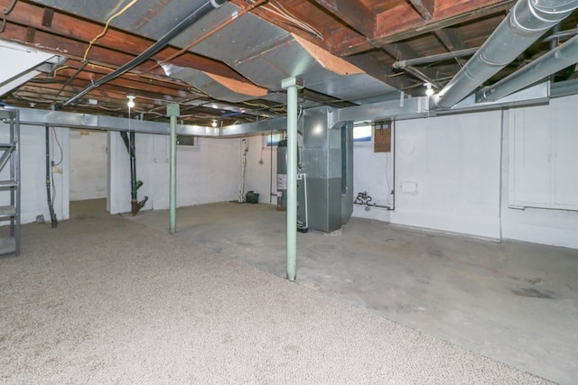 below grade area featuring heating unit and gas water heater