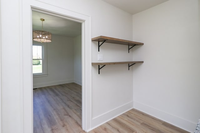 interior space featuring an inviting chandelier and wood finished floors
