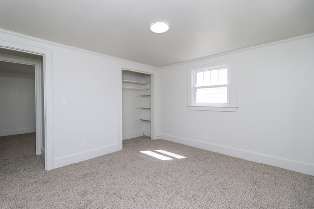unfurnished bedroom with a closet, baseboards, and carpet flooring