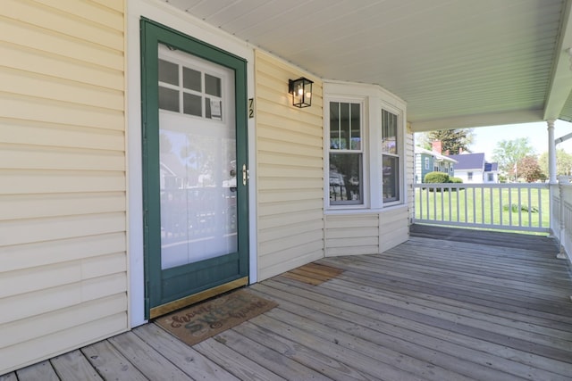 view of exterior entry with a porch