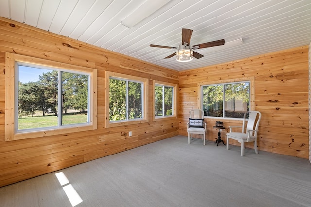 unfurnished sunroom featuring ceiling fan