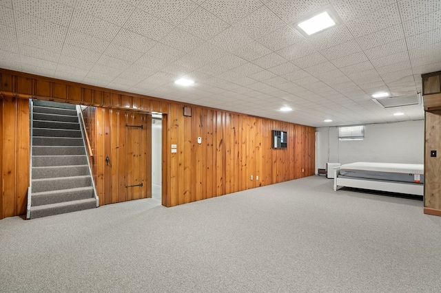 basement featuring wooden walls and carpet