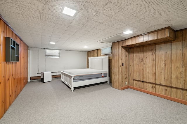 unfurnished bedroom featuring carpet flooring and wood walls