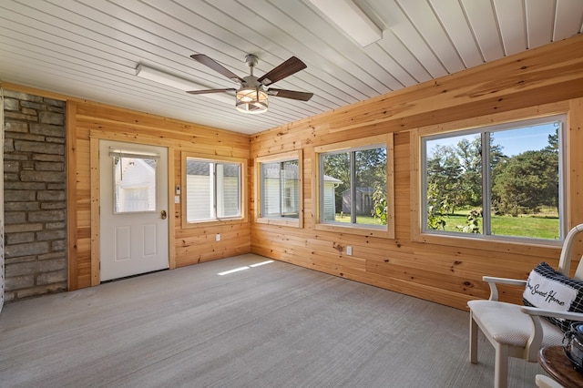 unfurnished sunroom with ceiling fan