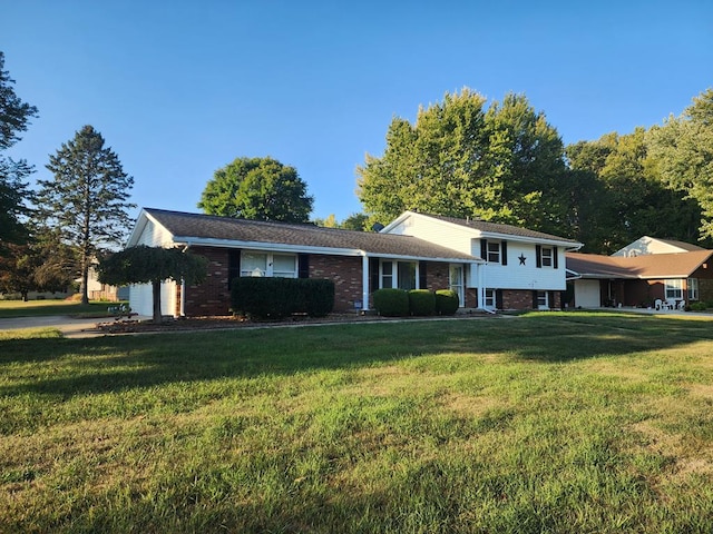 split level home with a front yard and a garage