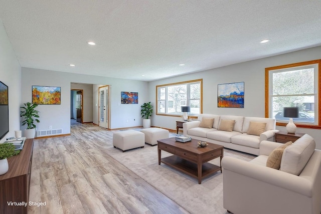 42 Kester Dr, Mount Vernon, OH 43050 - living room with a textured ceiling, light wood-type flooring, recessed lighting, and baseboards