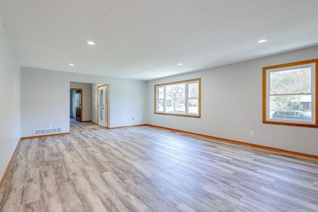 42 Kester Dr, Mount Vernon, OH 43050 - spare room with a textured ceiling, light wood-style floors, recessed lighting, and baseboards