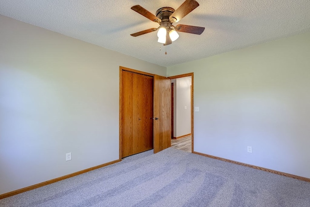42 Kester Dr, Mount Vernon, OH 43050 - unfurnished bedroom with light colored carpet, baseboards, a closet, and a textured ceiling