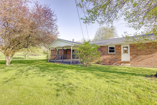 42 Kester Dr, Mount Vernon, OH 43050 - back of property with brick siding, a yard, and covered porch