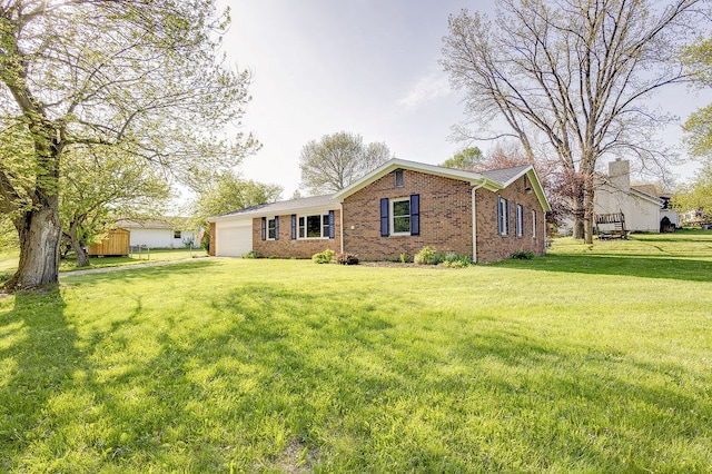 42 Kester Dr, Mount Vernon, OH 43050 - view of front of house featuring a garage, brick siding, and a front lawn