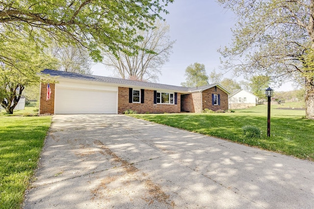 42 Kester Dr, Mount Vernon, OH 43050 - ranch-style house featuring a garage, brick siding, driveway, and a front yard