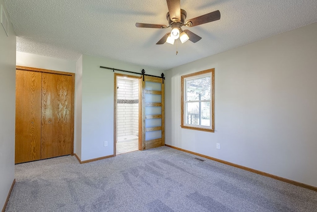 42 Kester Dr, Mount Vernon, OH 43050 - unfurnished bedroom with multiple windows, a textured ceiling, carpet flooring, baseboards, and a closet