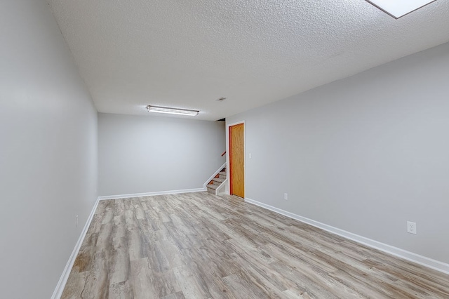 42 Kester Dr, Mount Vernon, OH 43050 - spare room featuring wood finished floors, a textured ceiling, stairway, and baseboards