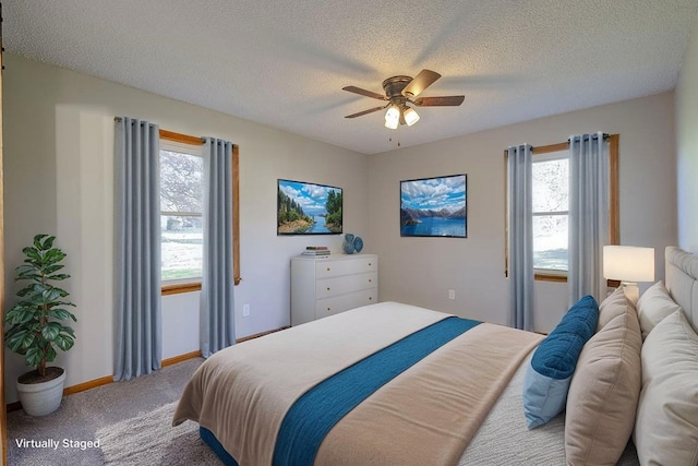 42 Kester Dr, Mount Vernon, OH 43050 - carpeted bedroom with baseboards, a textured ceiling, and ceiling fan