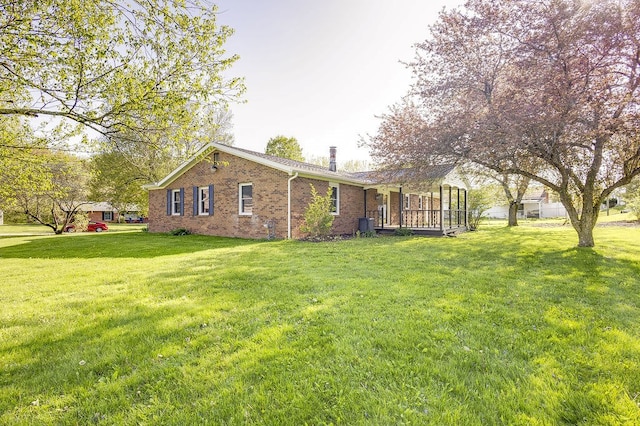 42 Kester Dr, Mount Vernon, OH 43050 - back of house with a chimney, a lawn, and brick siding
