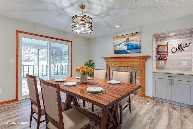 42 Kester Dr, Mount Vernon, OH 43050 - dining area with light wood finished floors, a chandelier, baseboards, recessed lighting, and a textured ceiling