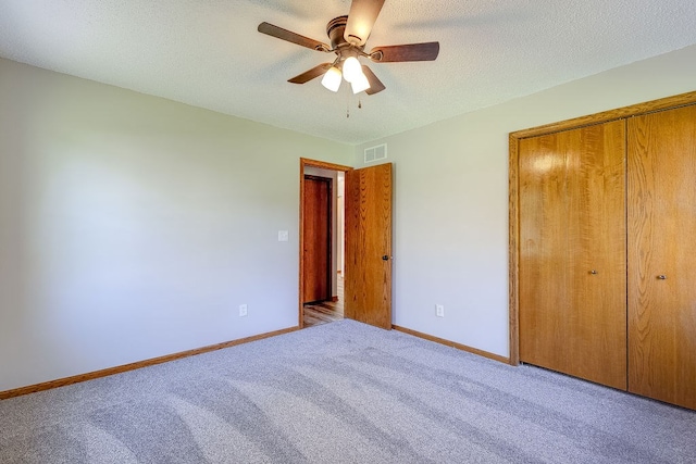 42 Kester Dr, Mount Vernon, OH 43050 - unfurnished bedroom with carpet, a closet, baseboards, a ceiling fan, and a textured ceiling