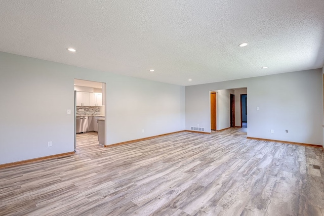 42 Kester Dr, Mount Vernon, OH 43050 - spare room featuring light wood finished floors, a textured ceiling, recessed lighting, and baseboards