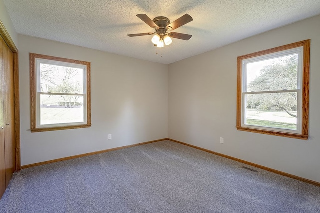 42 Kester Dr, Mount Vernon, OH 43050 - carpeted spare room featuring healthy amount of natural light, ceiling fan, baseboards, and a textured ceiling
