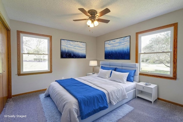 42 Kester Dr, Mount Vernon, OH 43050 - carpeted bedroom featuring multiple windows, baseboards, a textured ceiling, and ceiling fan