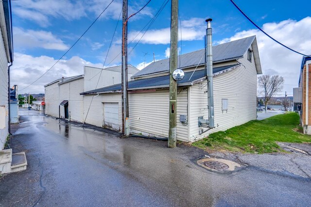 15 W Main St, Lexington, OH 44904 - misc room featuring wood finished floors, a drop ceiling, and a workshop area