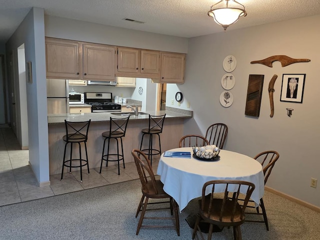 1683 Riva Ridge Dr, Mansfield, OH 44904 - dining space with light carpet and a textured ceiling