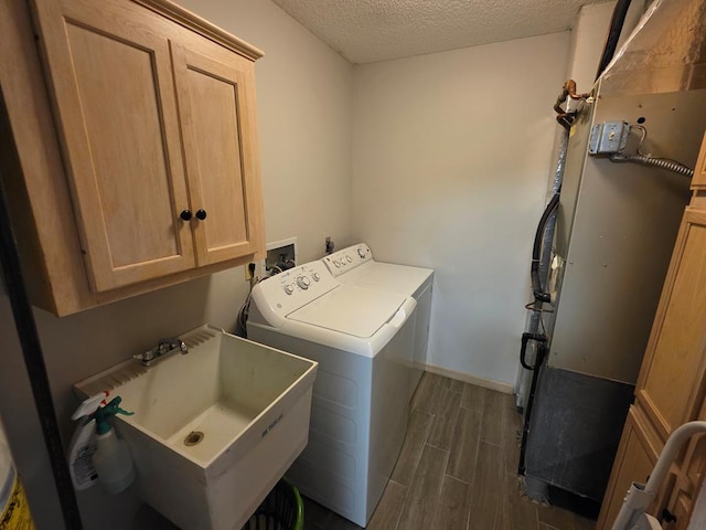 1683 Riva Ridge Dr, Mansfield, OH 44904 - washroom with separate washer and dryer, cabinet space, a textured ceiling, and wood tiled floors