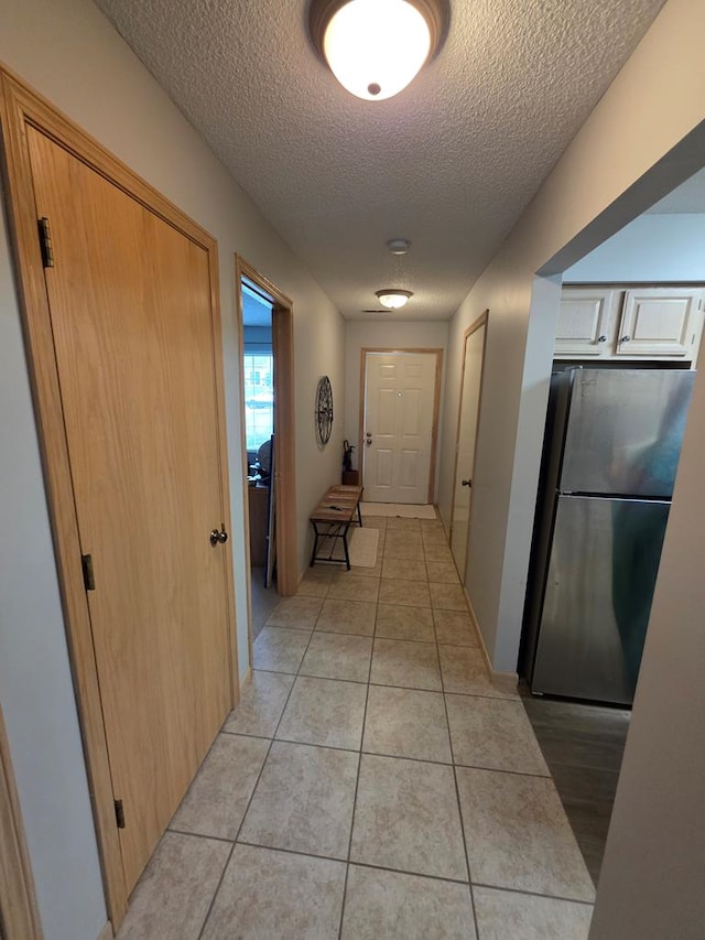 1683 Riva Ridge Dr, Mansfield, OH 44904 - hall with a textured ceiling and light tile patterned floors
