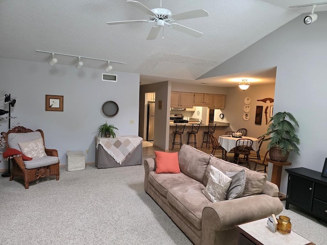 1683 Riva Ridge Dr, Mansfield, OH 44904 - living room featuring track lighting, vaulted ceiling, ceiling fan, light carpet, and a textured ceiling