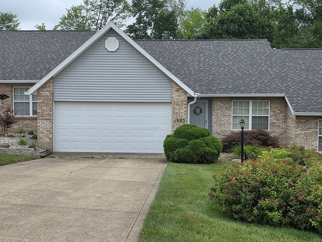1683 Riva Ridge Dr, Mansfield, OH 44904 - view of front facade with brick siding, driveway, roof with shingles, and an attached garage