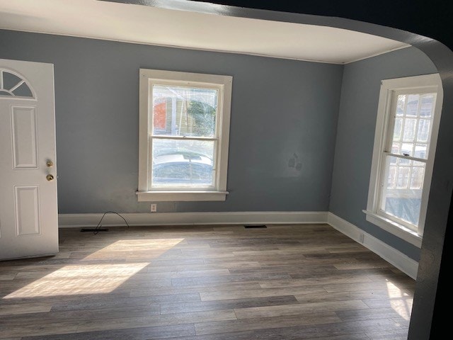 645 Wilson Ave, Marion, OH 43302 - spare room featuring a wealth of natural light, arched walkways, and wood finished floors