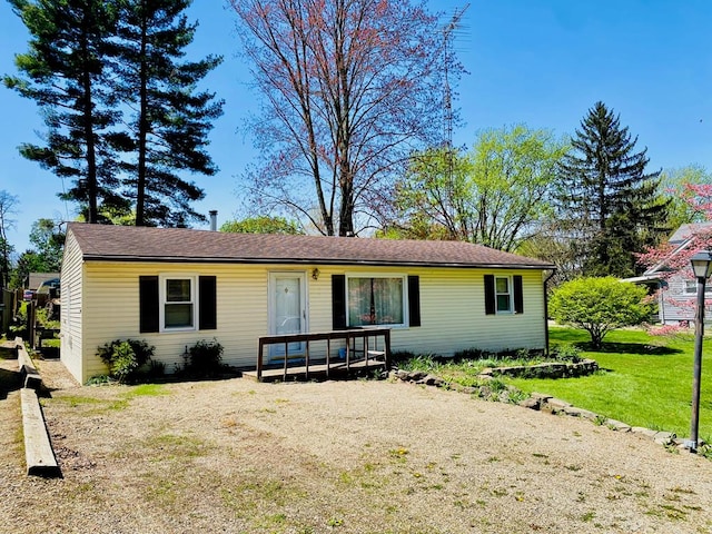 ranch-style home with a front lawn and a deck