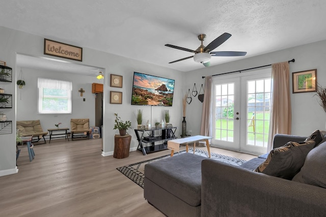62 Brushwood Dr, Mansfield, OH 44907 - living area with french doors, healthy amount of natural light, light wood-type flooring, ceiling fan, and a textured ceiling