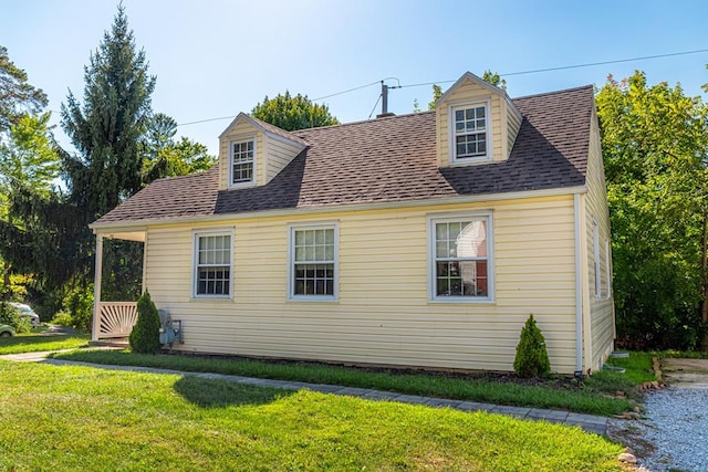 view of side of home with a yard